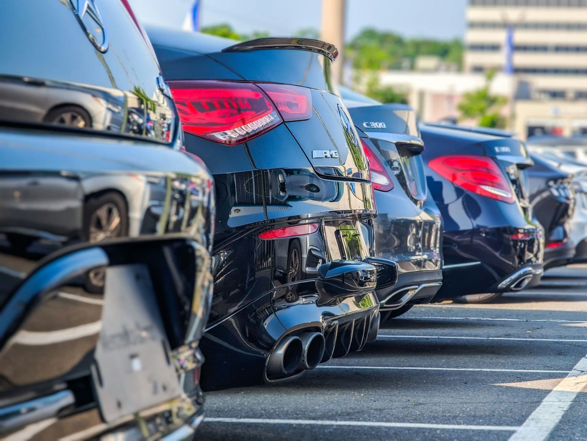 A row of black cars parked together