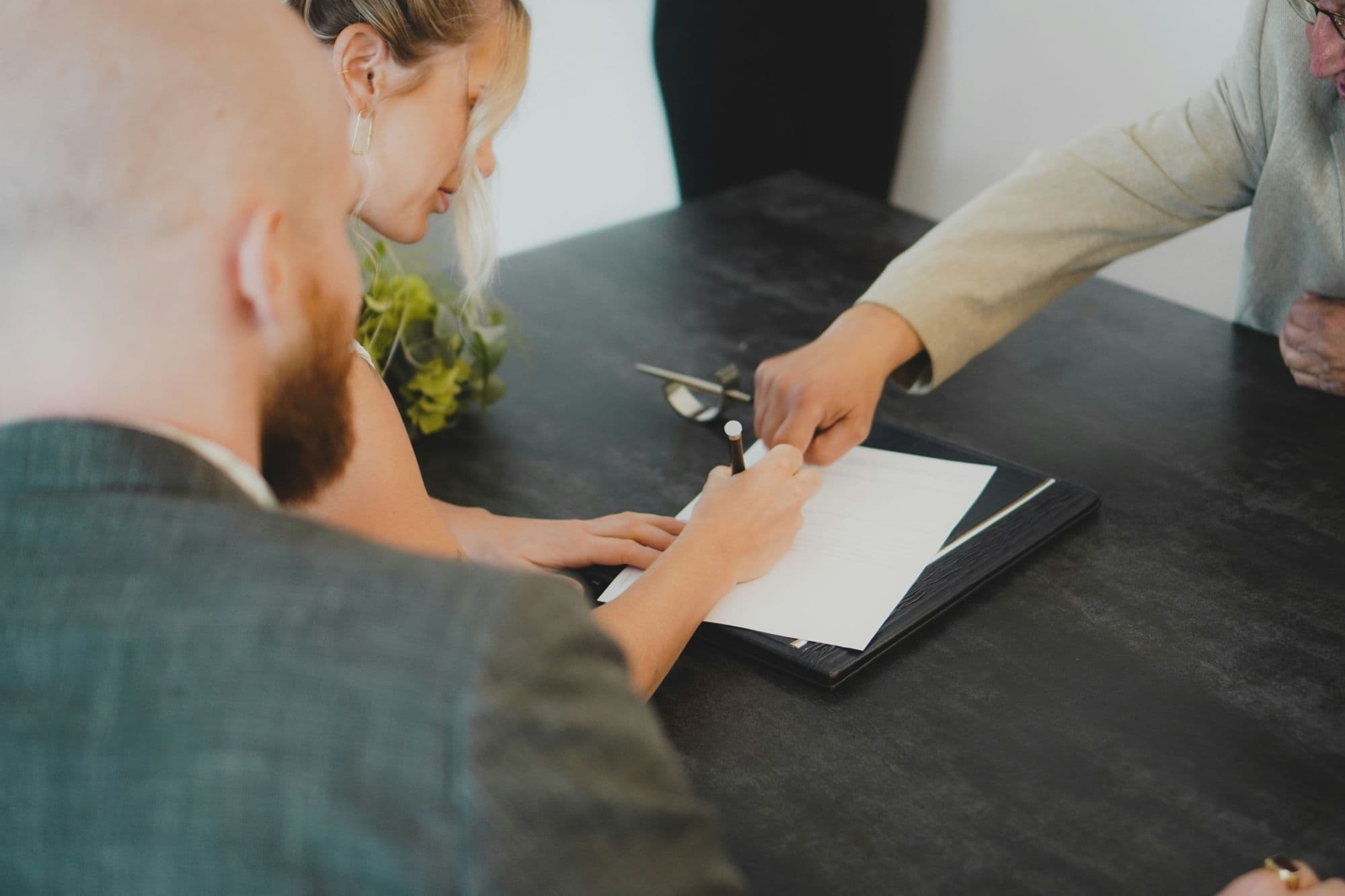 A customer signing an agreement at the desk
